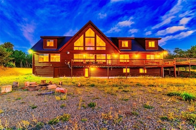 Back house at dusk with a wooden deck