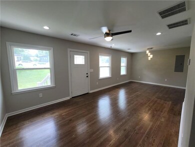 Entryway featuring a ceiling fan, electric panel, dark wood-style floors, and recessed lighting