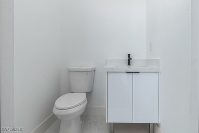Bathroom with vanity and marble look tiles
