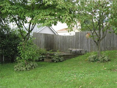 Privacy-Fenced Corner of Yard with Deck