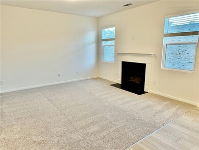 Unfurnished living room with a fireplace with flush hearth, wood finished floors, and carpet floors