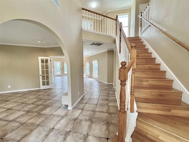 Stairs with plenty of natural light, crown moldin