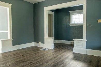 Unfurnished room featuring dark wood-type flooring