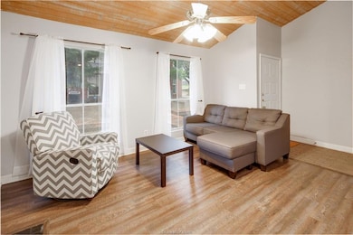 Living area featuring wood ceiling, a ceiling fan, light wood-style flooring, and lofted ceiling