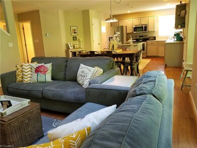 The Living Room runs seamlessly through to the dining room and  kitchen..  Wood laminate flooring adorns the main level entertaining areas,