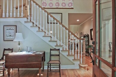 Entrance foyer with welcoming warm real wood floors