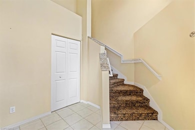 Stairs featuring light tile patterned floors