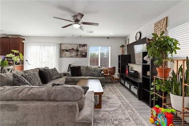 Living area with light wood-type flooring and a ce