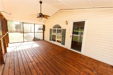 Unfurnished sunroom with ceiling fan and a wealth 