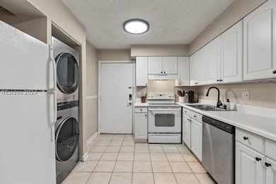 A view of the kitchen with a new washer and dryer