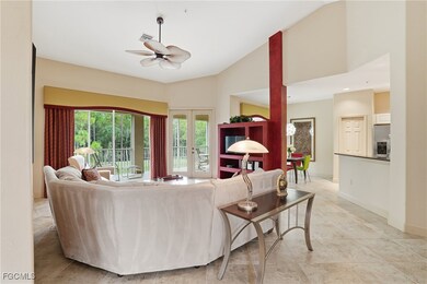 Living room featuring ceiling fan, high vaulted ceiling, and french doors