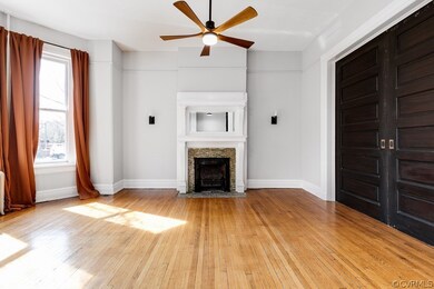 Unfurnished living room featuring light hardwood / wood-style floors and ceiling fan