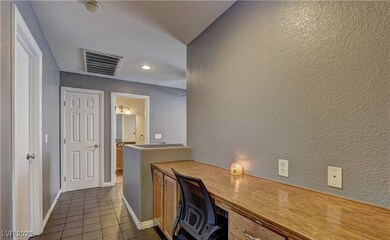 Office featuring dark tile patterned floors, visib