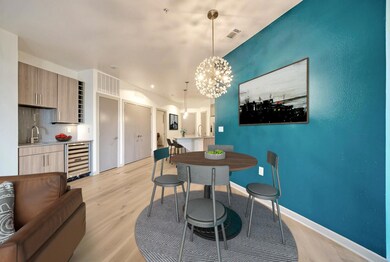 Dining area featuring beverage cooler, light wood