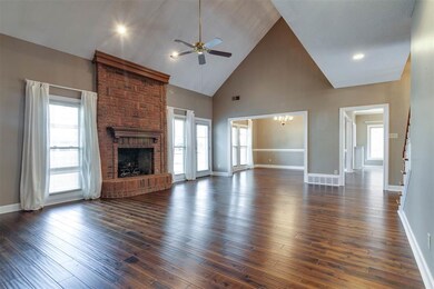 Masonry fireplace with gas logs is the focal point
