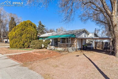 View of front of home featuring gravel driveway, c