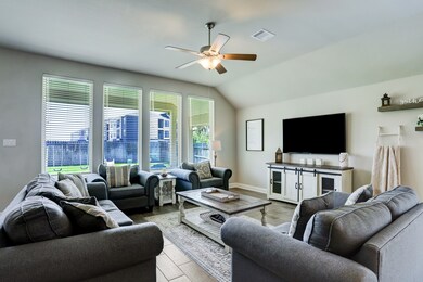 LIVING AREA  Abundant natural light pours in through walls of windows.  High ceiling and gleaming wood look tile complete the space.