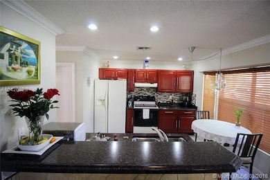 Updated kitchen with recessed lighting, bay window