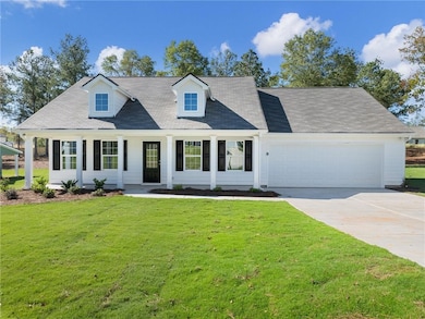 Cape cod home with a front yard and a garage
