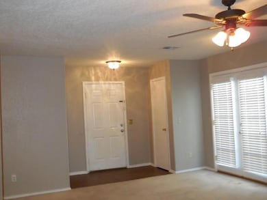 Carpeted spare room with ceiling fan, baseboards, 