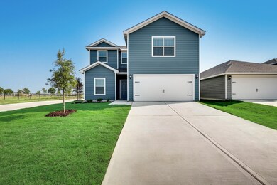 View of front of property with concrete driveway, a front yard, and an attached garage