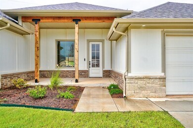 View of exterior entry with a garage