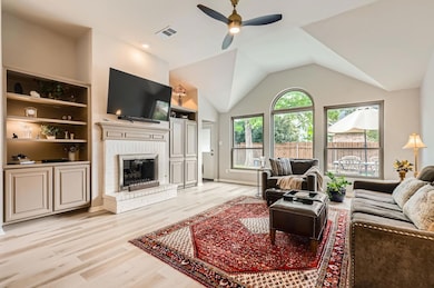 Living room with a ceiling fan, light wood-style 