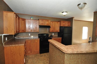 Kitchen with black appliances, under cabinet rang