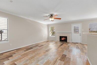 The living room has new wood plank tile flooring.