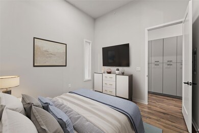Bedroom featuring wood finished floors and basebo