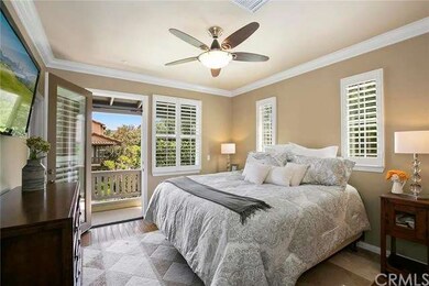Large master bedroom with hardwood floors, plantat
