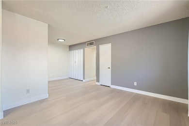 Living room w/ view of washer/dryer closet and din