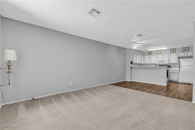 Unfurnished living room featuring dark colored car