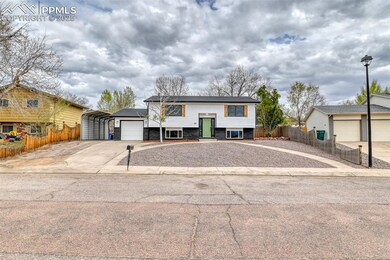 Bi-level home with driveway, a detached carport, a