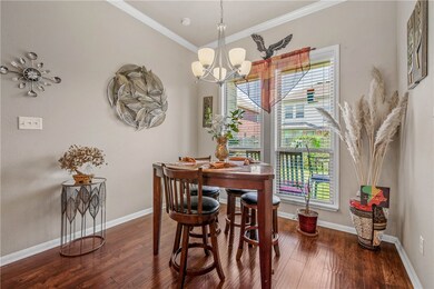 Dining room featuring wood finished floors, crown