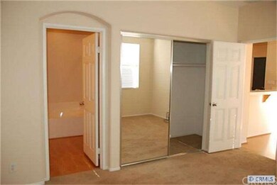 Master suite with mirrored closet doors to walk in