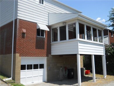Rear view of home, garage and Sun/3 Season Room