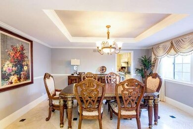 Dining Area with Trey Ceilings off Living Room 