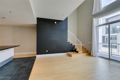 Unfurnished living room with baseboards, a high ce