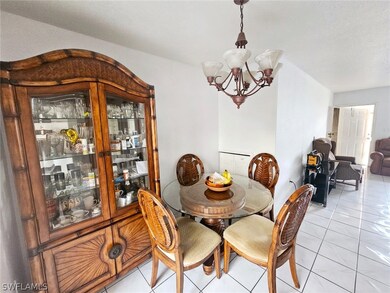 Tiled dining area featuring a chandelier