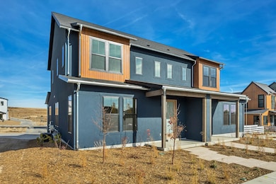 Back of house featuring covered porch and stucco siding