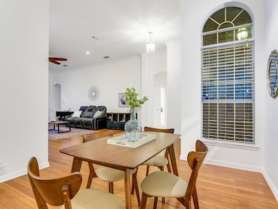 Dining room with arched walkways, baseboards, and