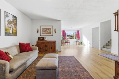 Living area featuring wood finished floors and stairs