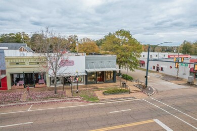 View of property with uncovered parking