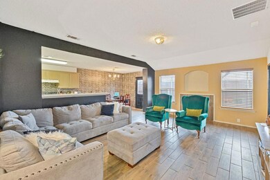 Living room featuring an inviting chandelier, visi