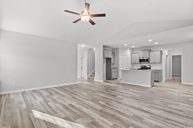 Unfurnished living room with sink, high vaulted ce