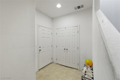 Doorway to outside featuring tile patterned floors and recessed lighting