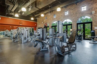 Workout area featuring a high ceiling, brick wall, and french doors