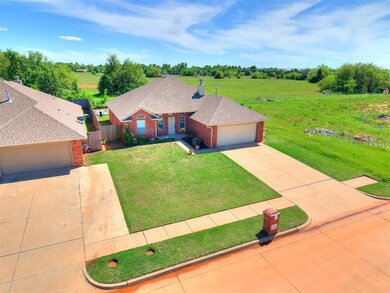 Ranch-style house with a garage, a front lawn, fen