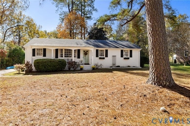 Ranch-style house featuring covered porch and a front yard